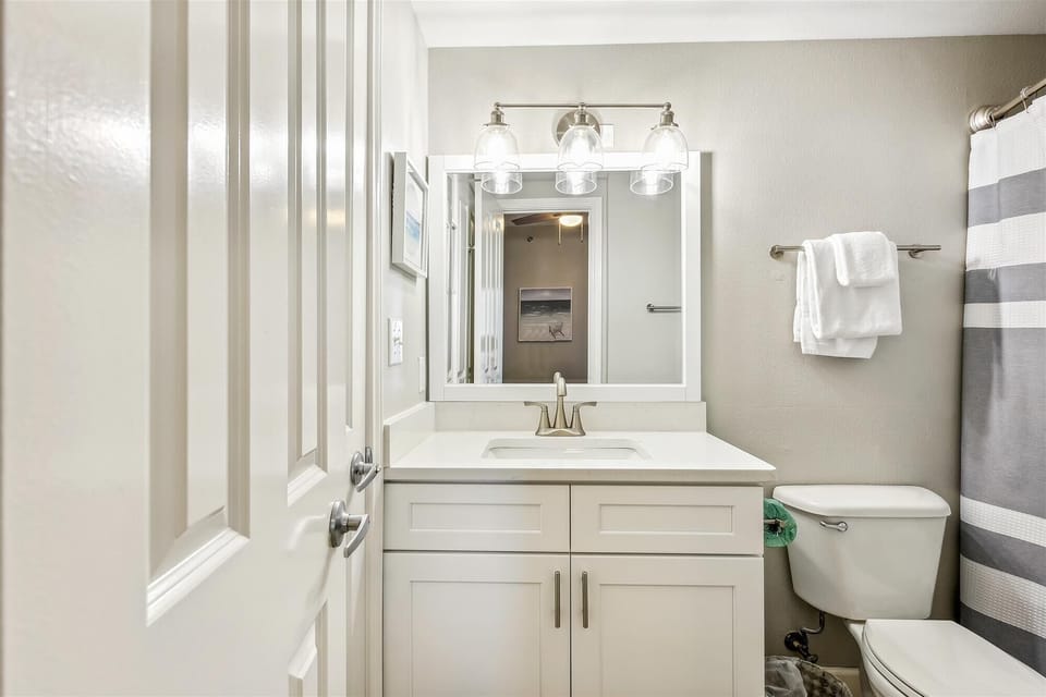 Private Bathroom in King bedroom with vanity, toilet and shower tub combo