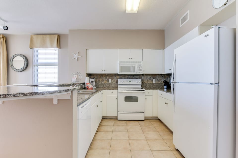 Kitchen with stove microwave refrigerator
Standard coffee pot
