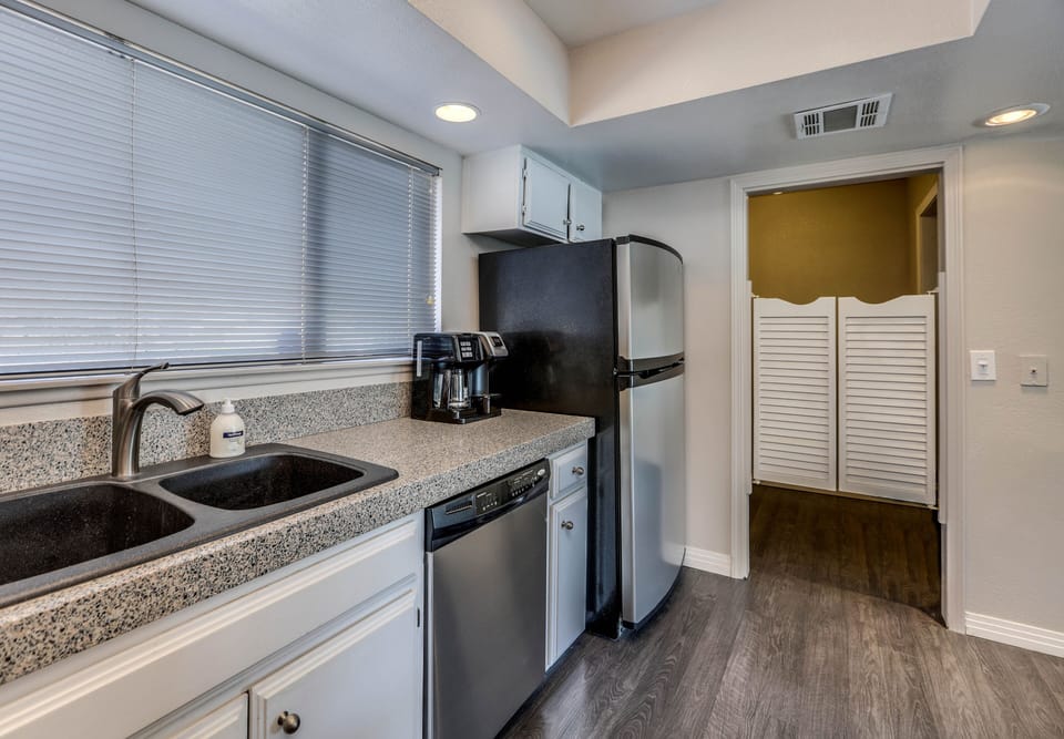 Kitchen with stainless appliances, coffee station, and easy access to dining