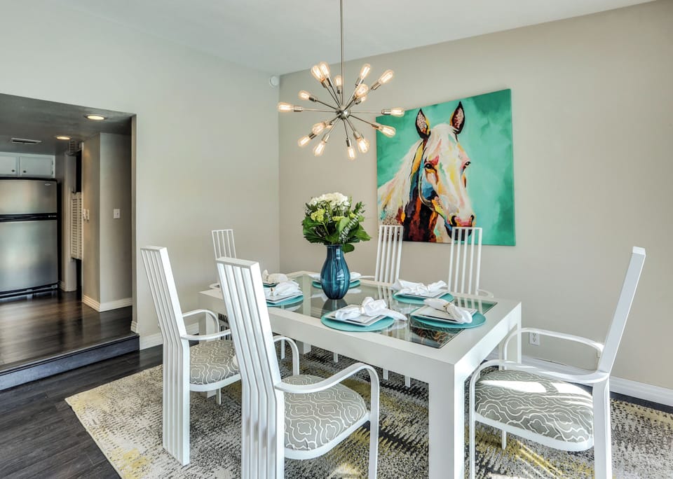 Modern dining area with designer lighting and seating for six