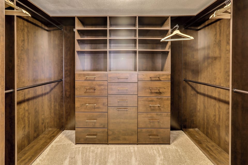 Large walk-in closet with custom shelving and ample storage space