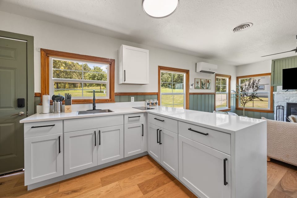 Modern kitchen with everything you need, surrounded by natural light and views of the outdoors