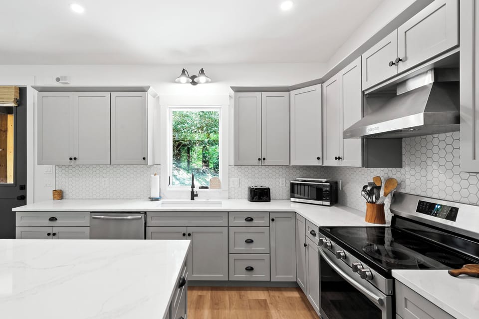 Kitchen with spacious island, dishwasher, and drip-style coffee maker