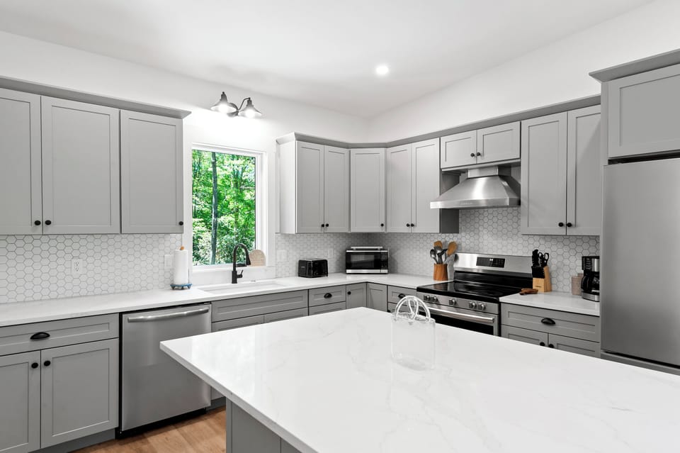 Kitchen with spacious island, dishwasher, and drip-style coffee maker