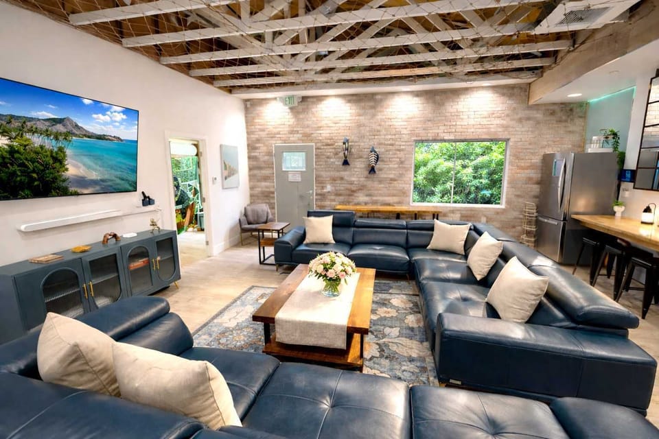 Open-Concept Living Room Featuring 4 Sofa Beds, Expansive Seating, and a Comfortable Resort-Style Layout — Ideal for Lounging, Social Time, and Extra Sleeping Space