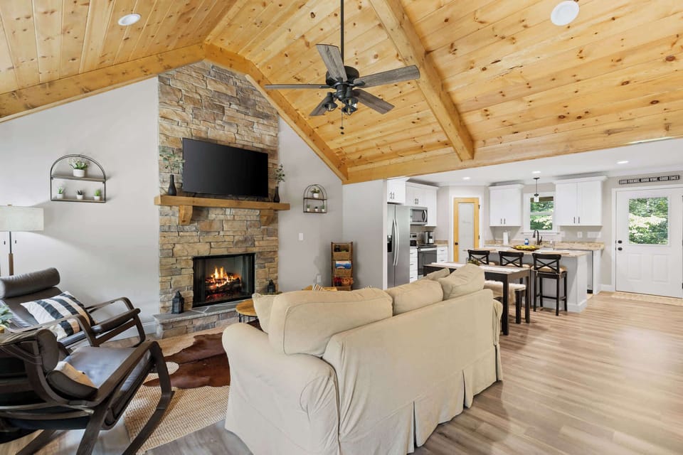 Enjoy the spacious open floor concept that flows seamlessly into a cozy living room, complete with a warm indoor fireplace — perfect for relaxing gatherings.