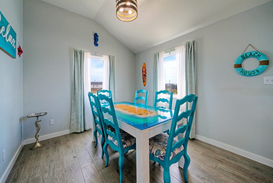 The dining area features a colorfully designed table and vibrant wall decor—perfect for gathering in style and enjoying meals with a cheerful touch. (Sandy Feet Retreat)