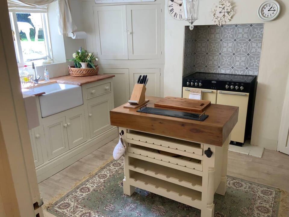 Basement Level - Kitchen with views of the Garden - Electric range, cafetiere, butlers sink, fridge freezer, microwave, ketttle and toaster.  The washing machine can be found in the utility area.