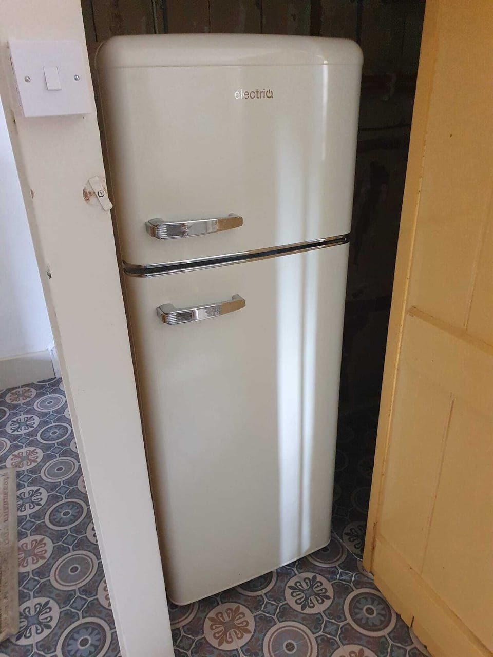 The Fridge-freezer is located inside this cupboard in the kitchen