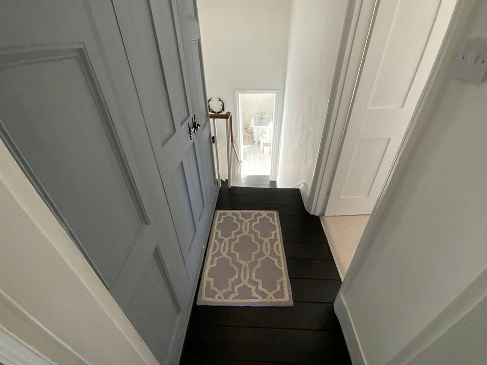 landing area - 1st floor leading to both bedroom and downstairs to half level with main bathroom.