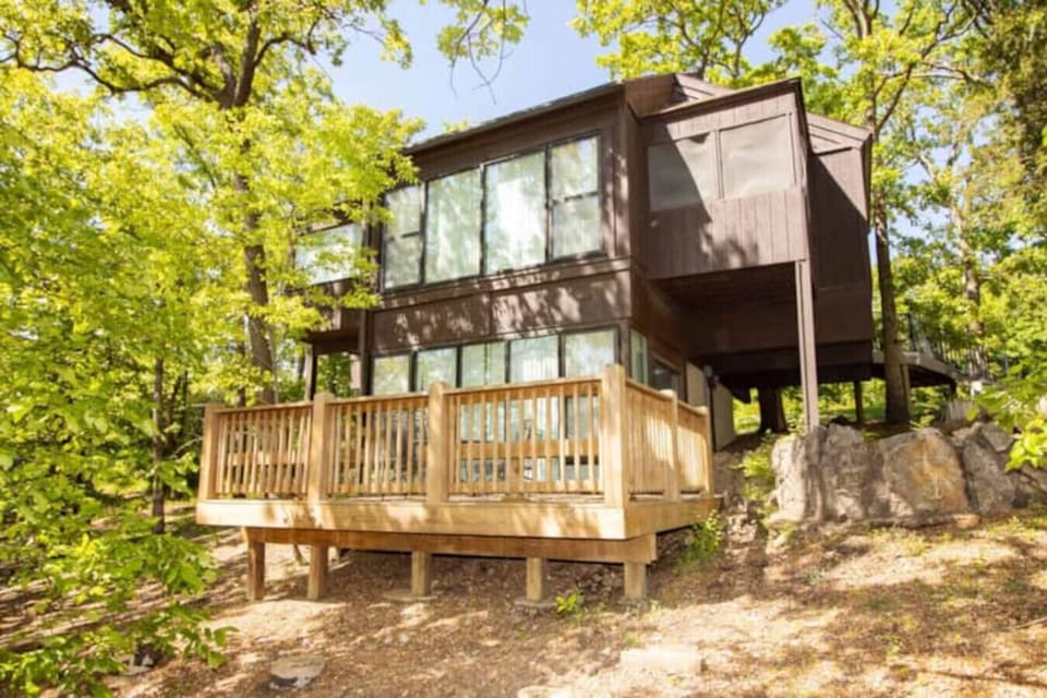 This modern elevated home offers a unique `treetop` living experience, blending seamlessly with the surrounding lush natural landscape. Multiple large windows allow for abundant natural light and scenic views, making this a bright and inviting retreat.
