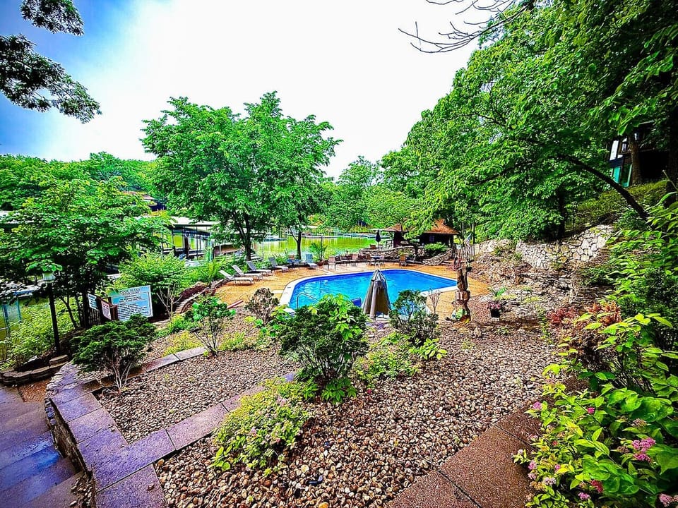 Descend to the inviting communal pool area at Lakefront Treetop Village, offering a refreshing oasis with stunning views of the lake and surrounding greenery.
