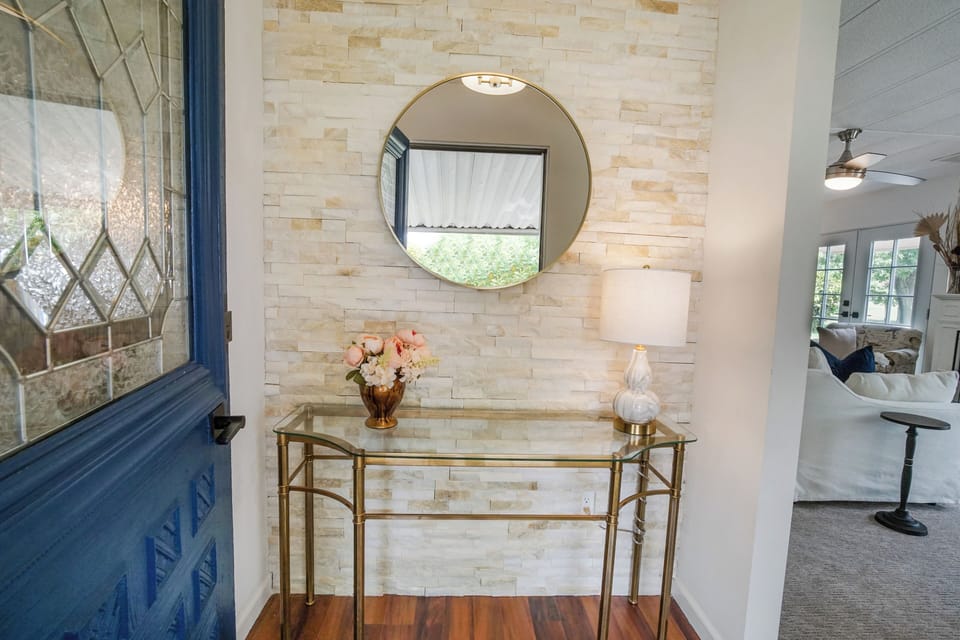 Stylish entryway with stone accent wall and welcoming console