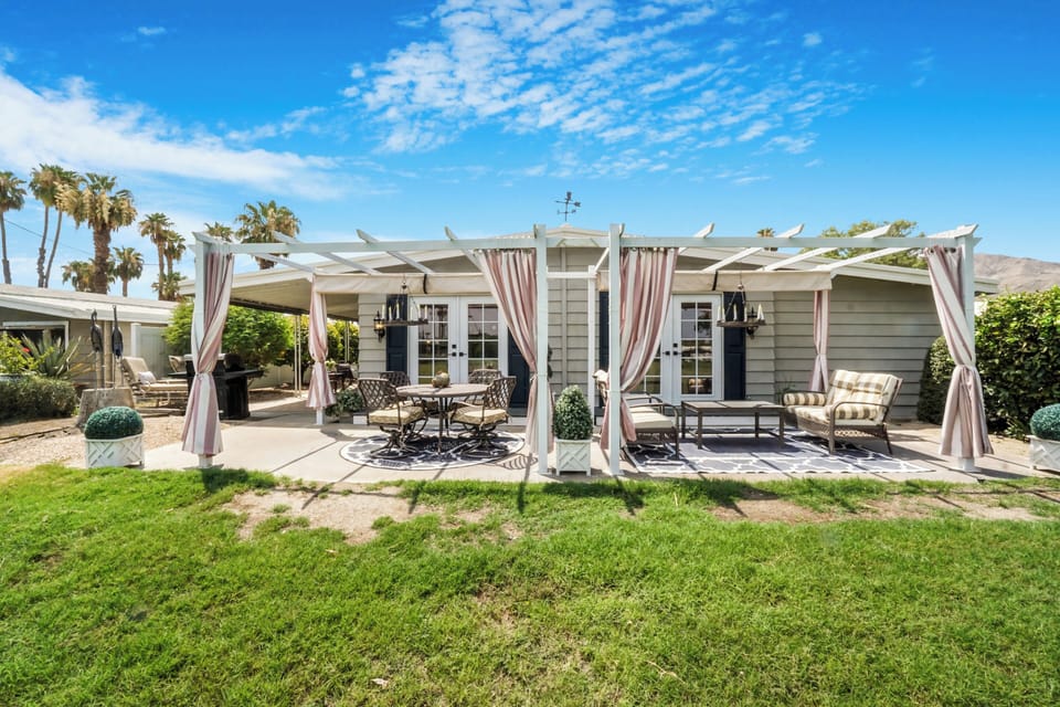 Resort-style backyard with pergola seating and sweeping golf course views
