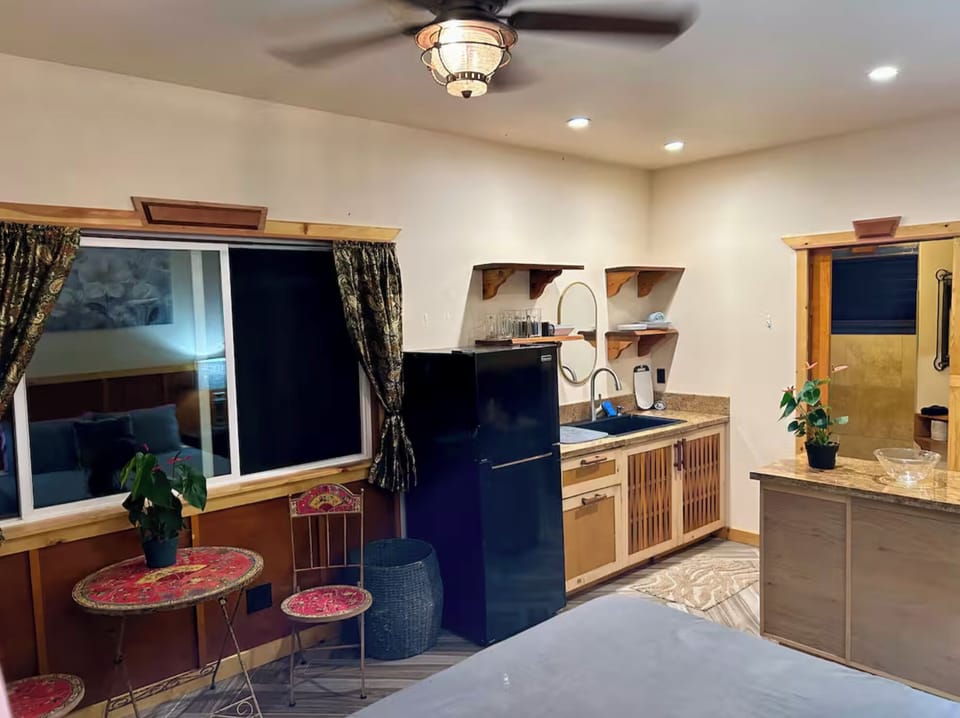 fridge and deep sink with shelves and custom cabinets