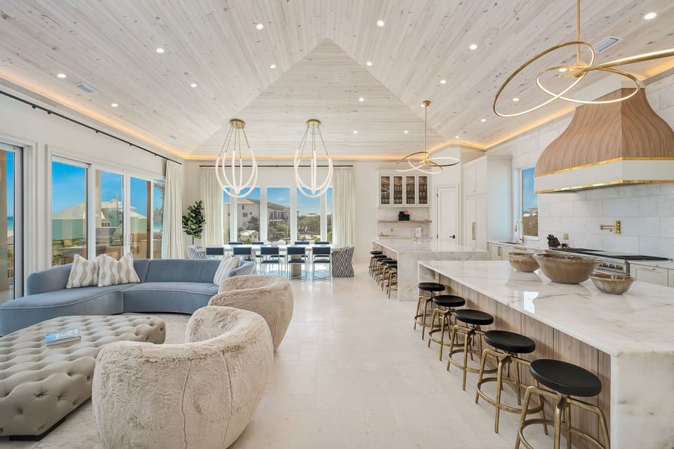 Gather together in this stunning open-concept space where soaring cathedral ceilings meet coastal elegance. Sink into plush seating while you chat, cook, and dine with loved ones in your bright, airy retreat.