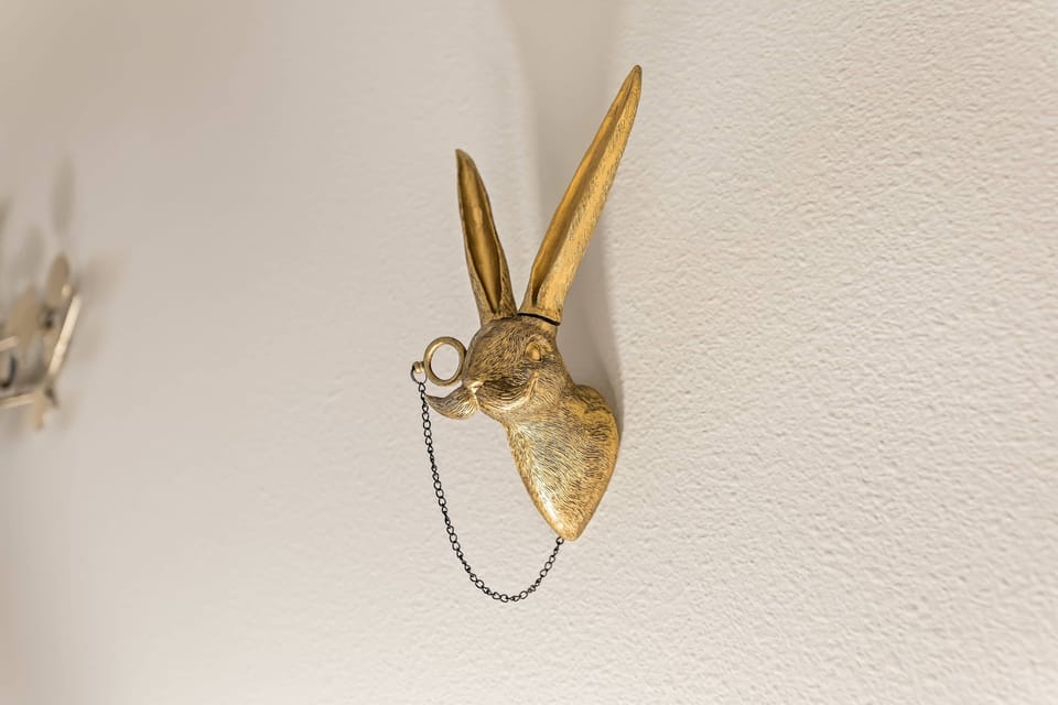 Chic wall detail — a gold bunny sculpture adding a touch of modern charm.