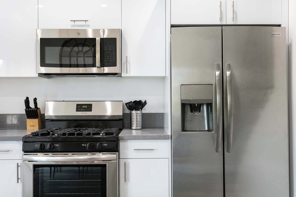 Fully equipped kitchen with stainless steel appliances.