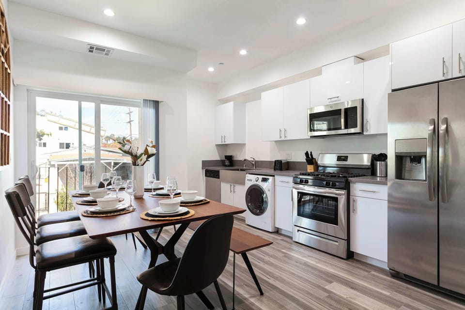 Bright open-concept kitchen with stainless steel appliances.