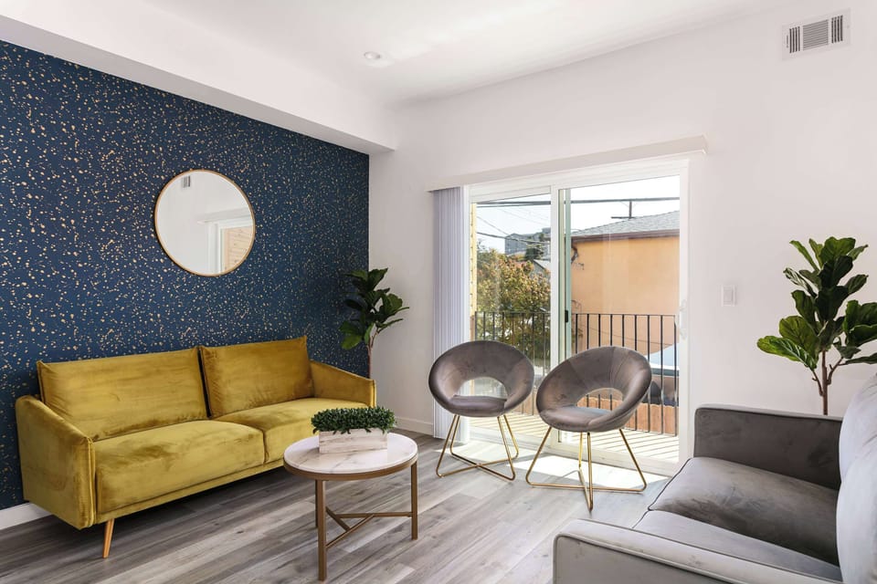 Cozy living room with accent wall and natural light.