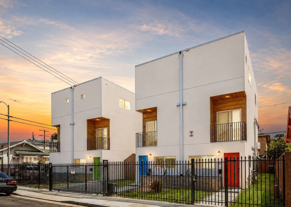 Modern exterior of the property at sunset with private gated entry.