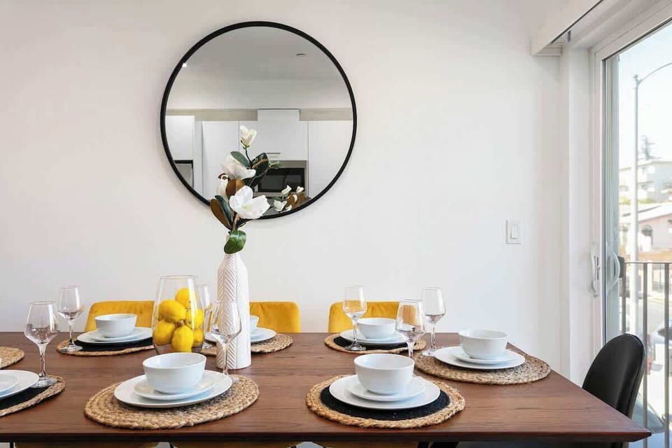 Tastefully designed dining area with decorative mirror and table setting.