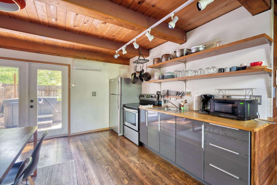 Kitchen with range and open shelving.