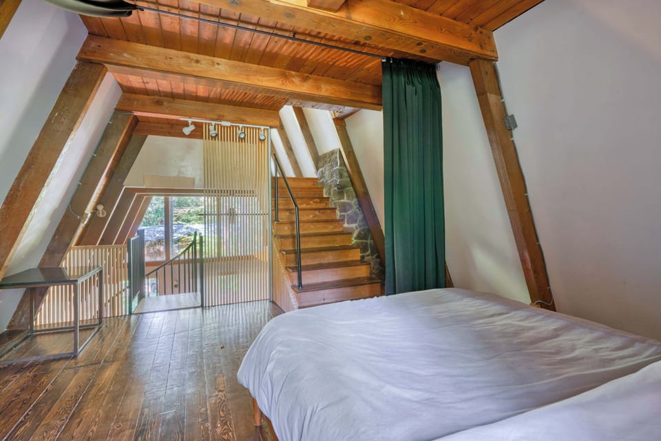 Bedroom 1 with queen bed and deck doors.