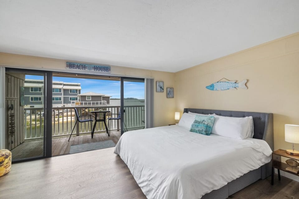 King bed with large sliding doors opening to the deck