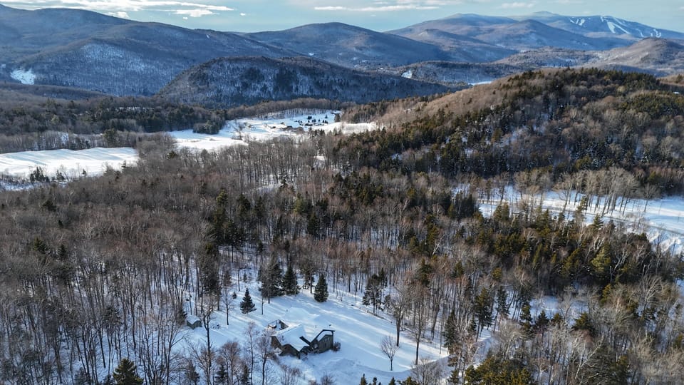 Aeriel view of house and Killington Mountain (top right)