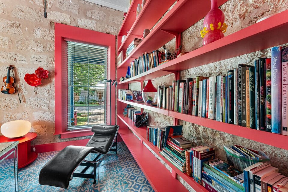 Cozy reading nook with a vibrant book collection.