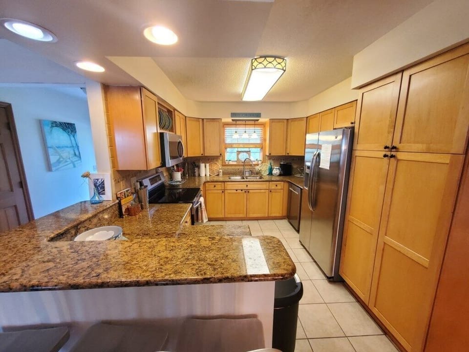 Fully-equipped kitchen with modern appliances and granite countertops.