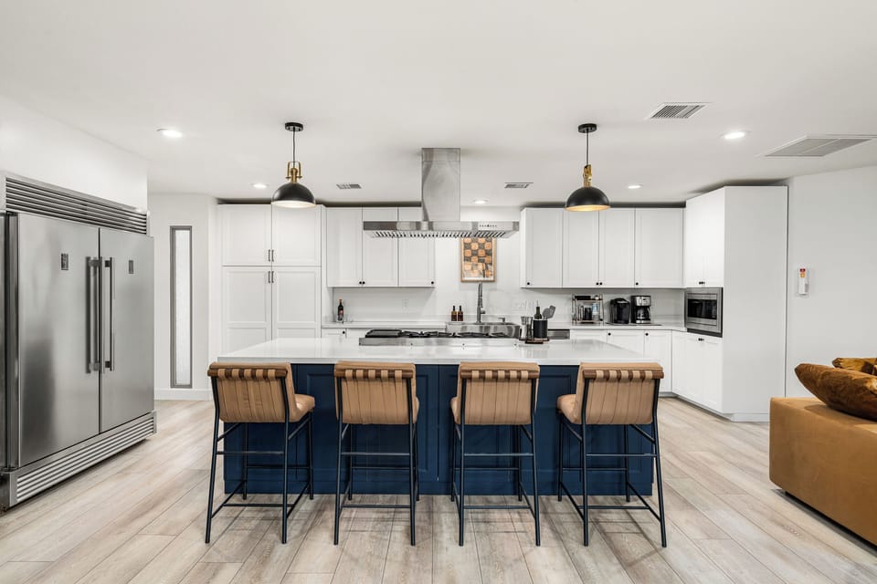 Cook in style – fully stocked, high-end appliances, and elegant island seating
