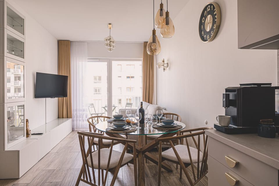 Apartment with dining area and kitchen – modern interior by the sea