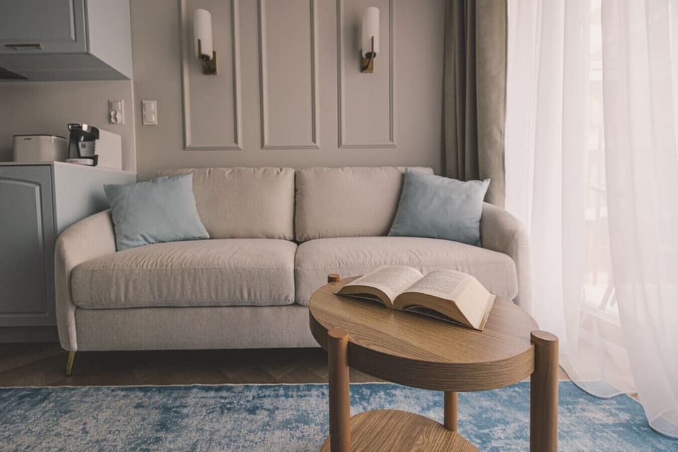 Cozy living area with sofa and book – unwind after exploring Mill Island.