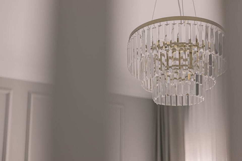 Elegant chandelier – luxurious details in Aura Apartment near Opera Nova and Mill Island.