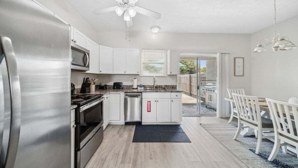 Open kitchen/eating area with view of backyard
