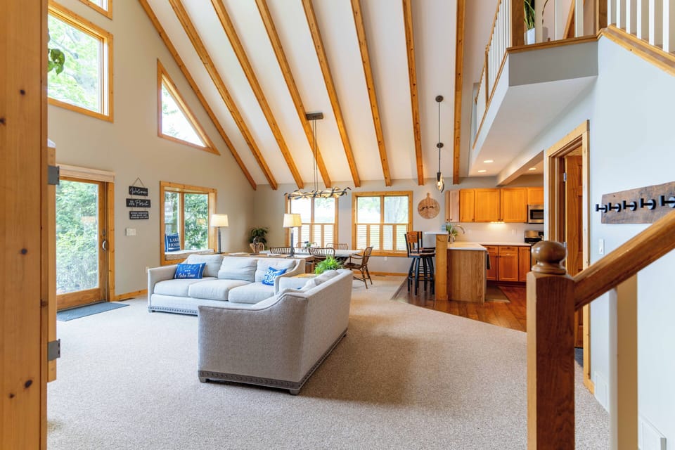 A comfortable living room with lake views and a smart TV as well as books and games for kids