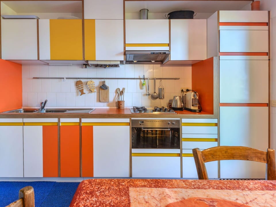 Yellow, Kitchen, Interior Design, Flooring, Countertop, Orange, Cabinetry, Room, Floor, Furniture