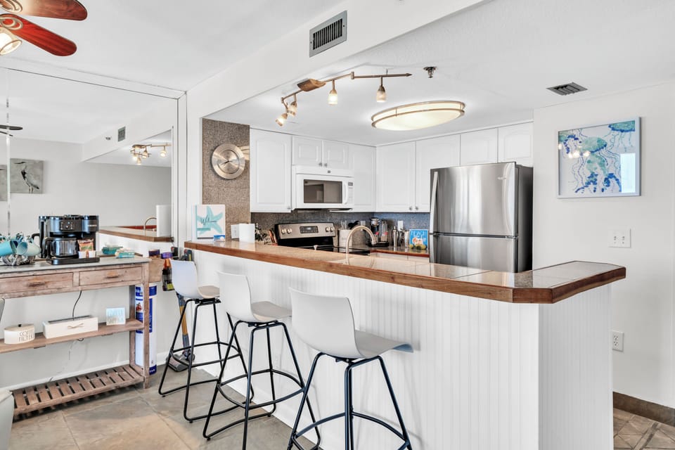 Your spacious kitchen welcomes you with modern appliances, generous counter space, and a breakfast bar perfect for casual meals and morning coffee.
