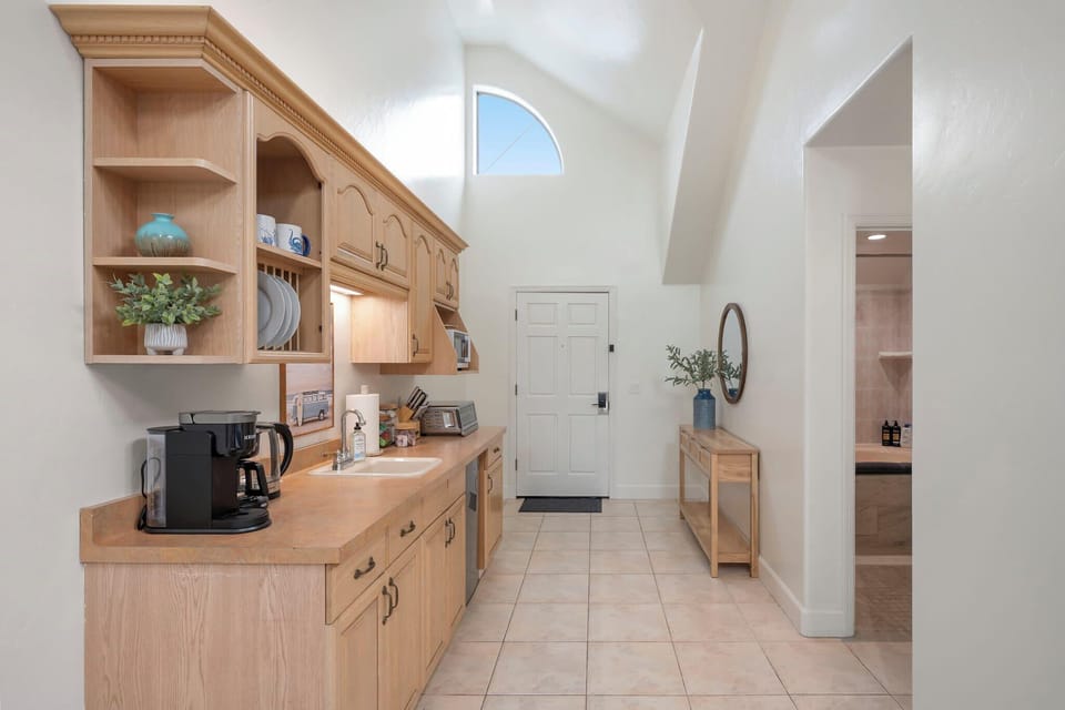 Well-equipped kitchen with coffee maker, microwave, toaster, and mini fridge