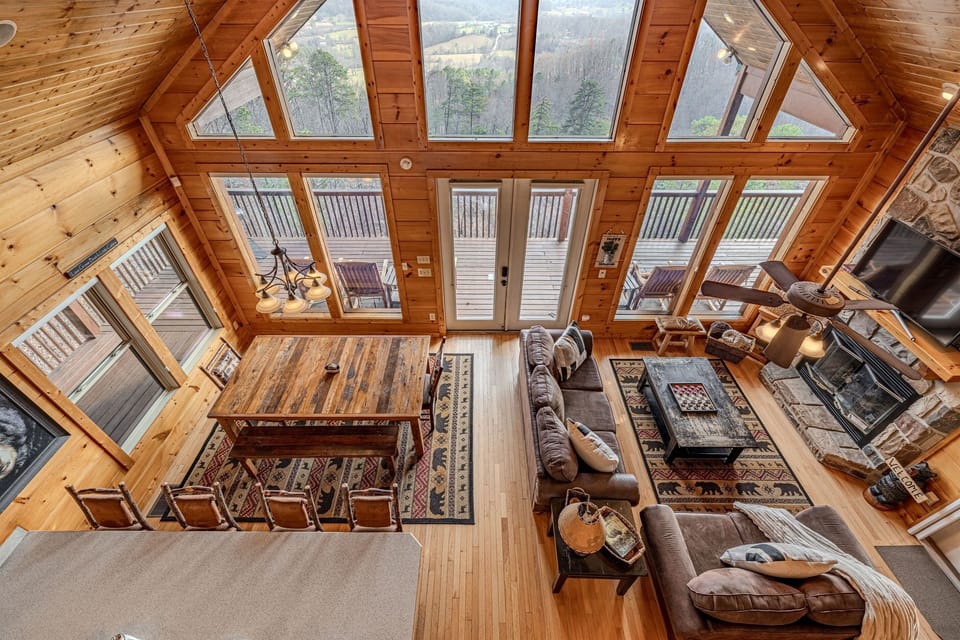 An elevated view of mountain luxury. From up here, you can see the stunning architecture, plush seating, and the majestic view framed outside.