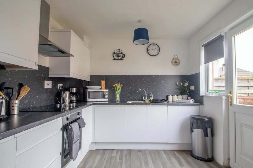 Full kitchen with complete appliances and essentials, ideal for convenient home cooking during your stay.