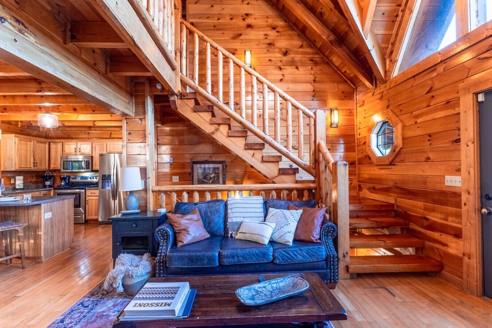 Open-Concept Living Space | Cozy Seating | Rustic Wood Interior | Warm Cabin Ambiance |