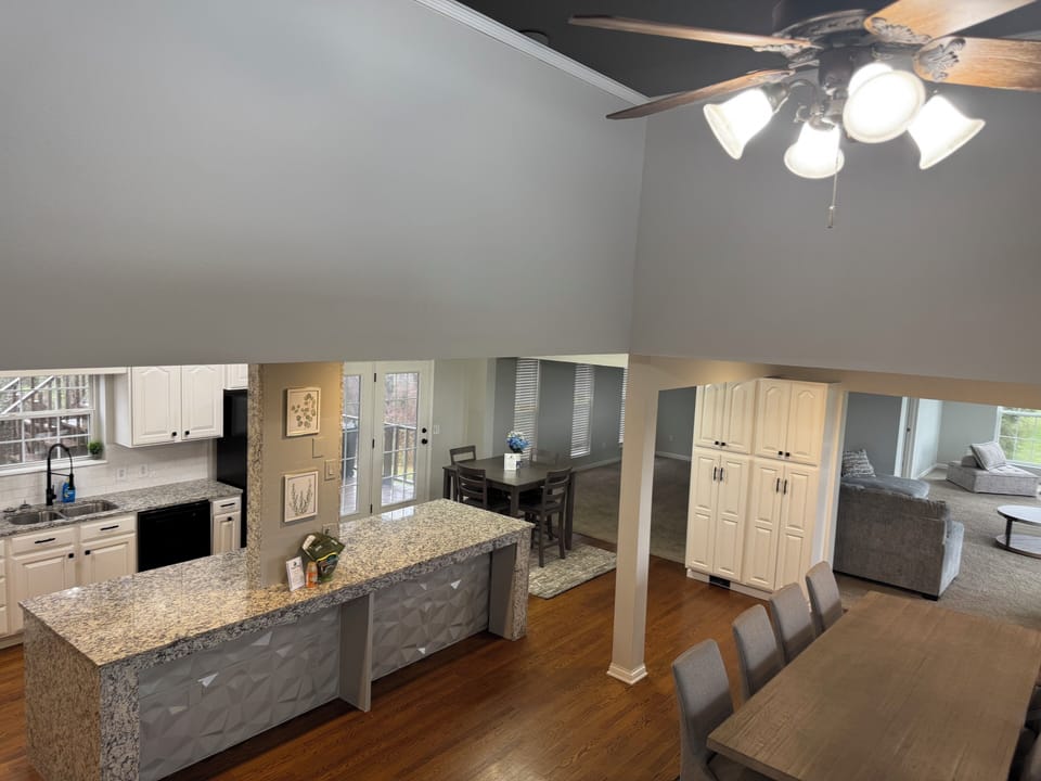 Spacious dining room with 2 tables to accommodate 14 plus 4 along the island.