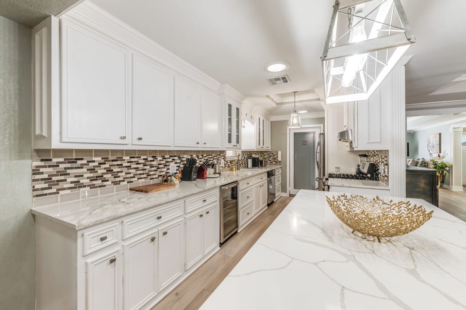 Cook with ease in a fully equipped kitchen featuring sleek countertops and stainless appliances.