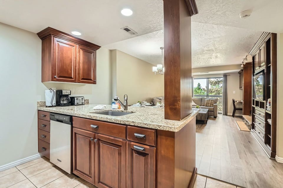 Compact, fully-equipped kitchen with a breakfast bar, open to the living area. Perfect for quick meals during your stay.