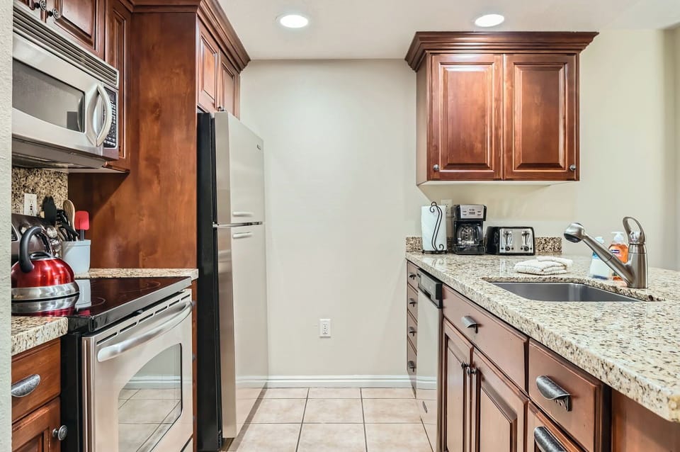 Compact, fully-equipped kitchen with a breakfast bar, open to the living area. Perfect for quick meals during your stay.