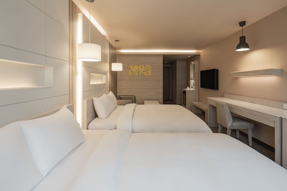 Business Quadruple Room | Living area | 48-inch LCD TV with cable channels, TV