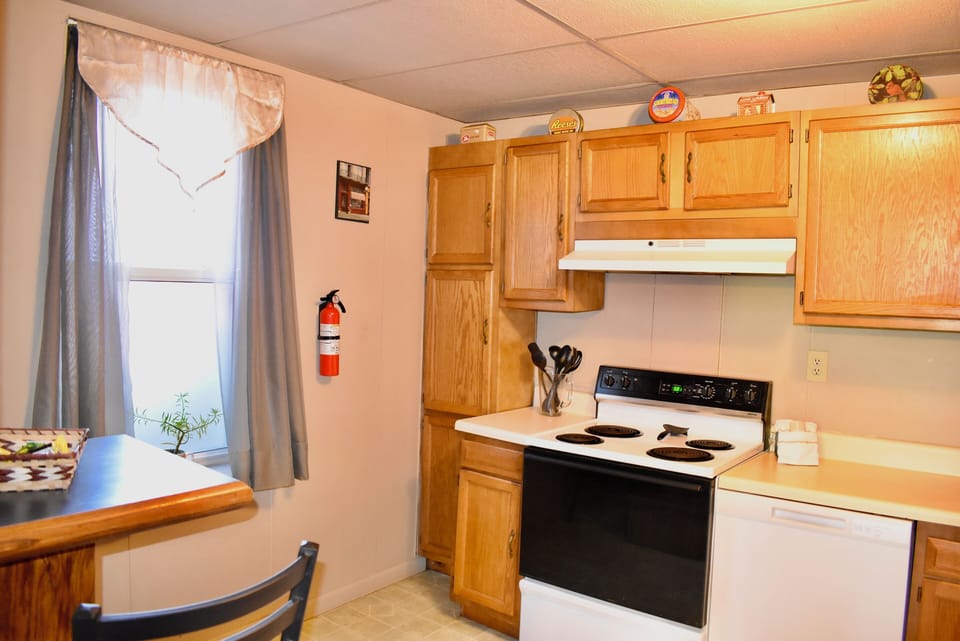 Small eat in area, dishwasher, toaster, microwave, pots, pans, utensils & dishes